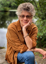 Author Susan Wilson, sitting and  looking at camera