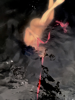 figure underwater with red ribbon