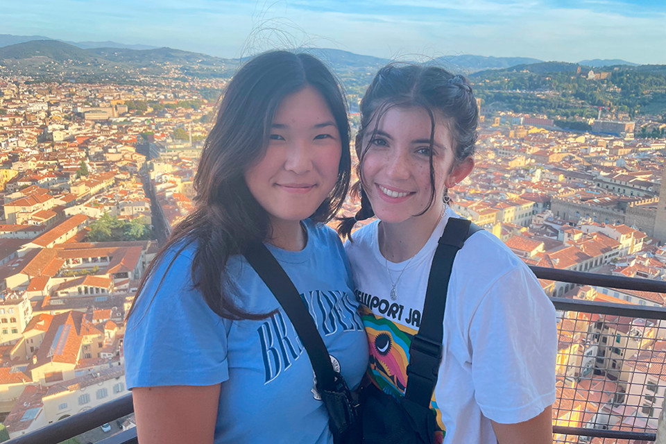 Two students standing in front of the cityscape in Florence, Italy