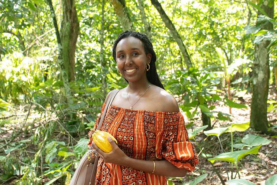 Student standing in a lush jungle 