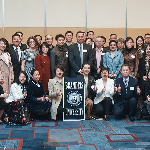 Liebowitz poses with members of the Brandeis community in Beijing.