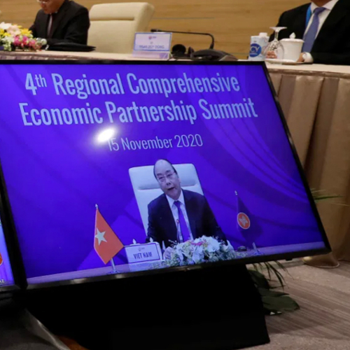 A diplomat speaks via virtual meeting at a trade summit.