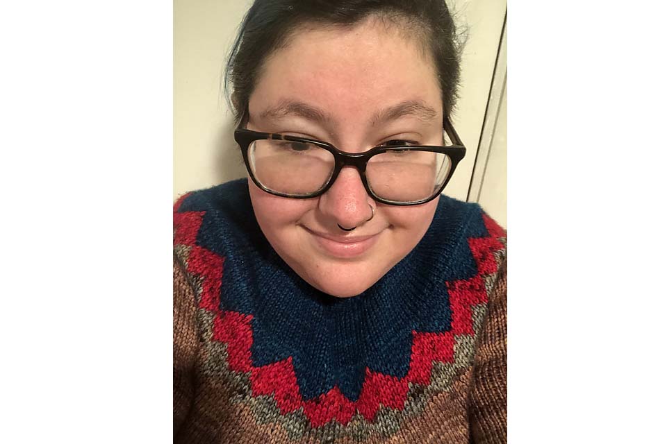 Cat Rosch wears a colorful sweater.