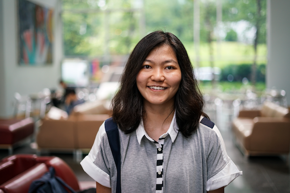 Headshot of Karina standing in a classroom with windows