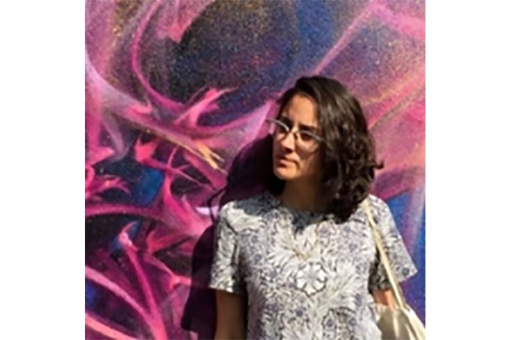 Patricia Alvarez Astacio in front of a mural