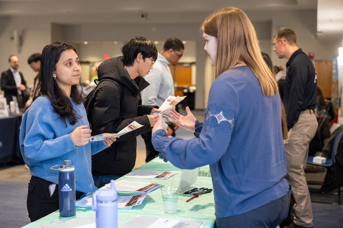 An employer poses for a photo during the 2022 Government & Public Service Career Fair