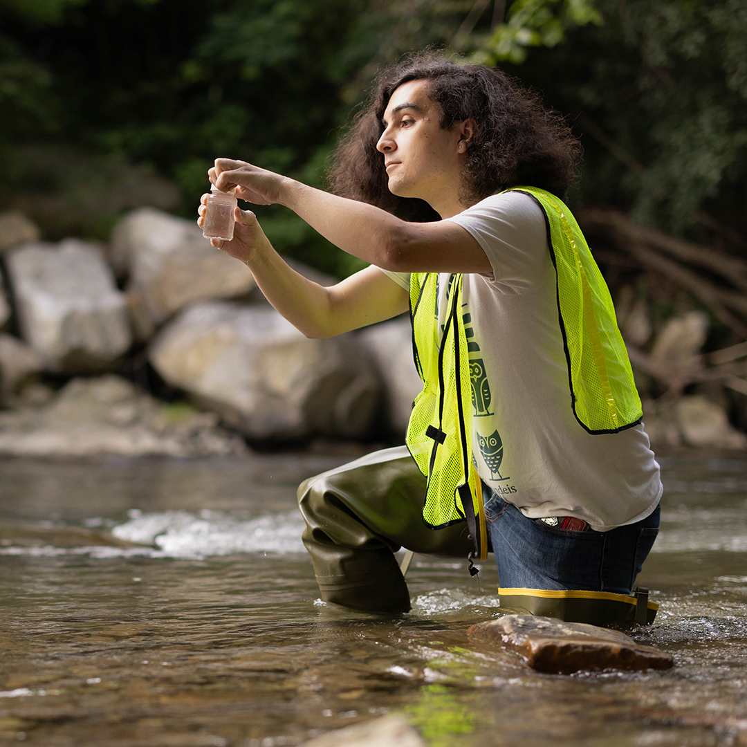 Lucas Forman '24 takes a water sample along the Hoosic River where he is interning for the Hoosic River Watershed Association (HooRWA) as part of the WOW fellowship program in along the Hoosic River on July 26, 2023. Photo/Dan Holmes