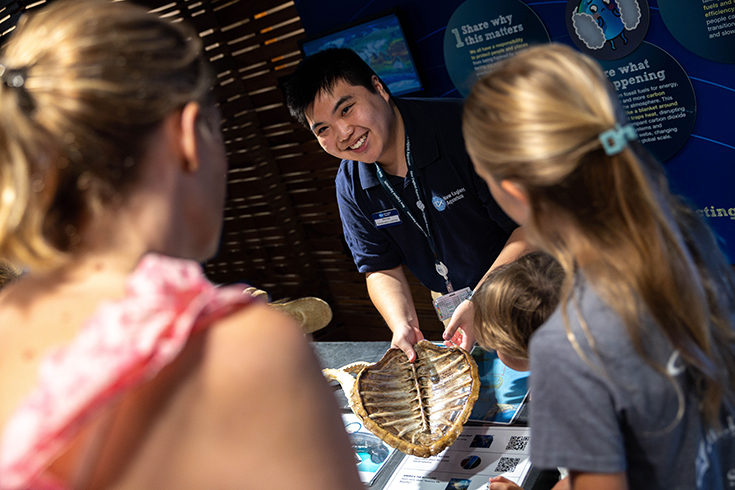 Declan Tsuyuki ’25, poses for a portrait at the New England Aquarium, where he interned as a 2023 WOW Fellow.