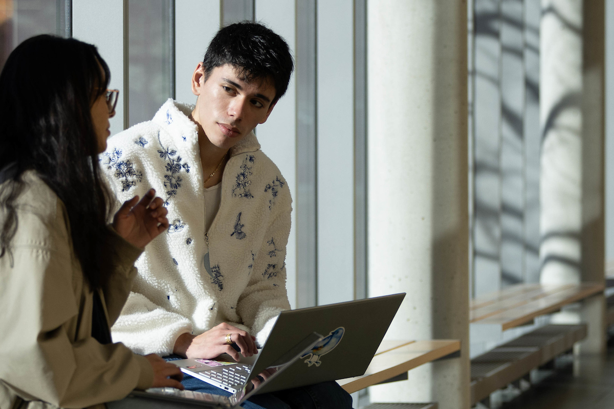 Monica Claros ’26 and Justin Koizumi ’27 wait in the hallway for their class to start in the Mandel Center for the Humanities during the first day of classes of the Spring 2025 semester at Brandeis University on January 14, 2025.