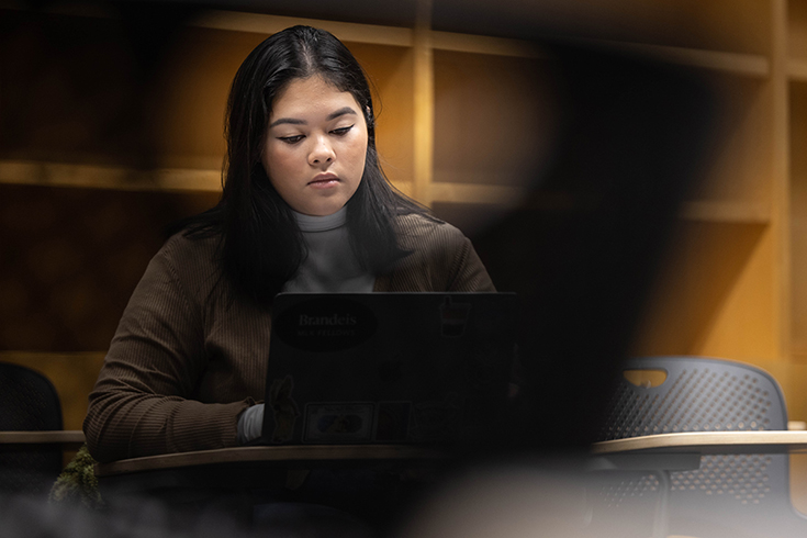 Amelia Trahan '24 works in her class "Medieval Women in Print” at Brandeis University on January 26, 2023. Photo/Dan Holmes