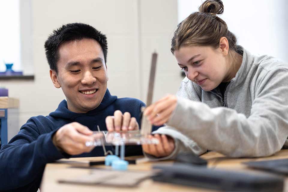 Brandeis students engaged in a lab experiment