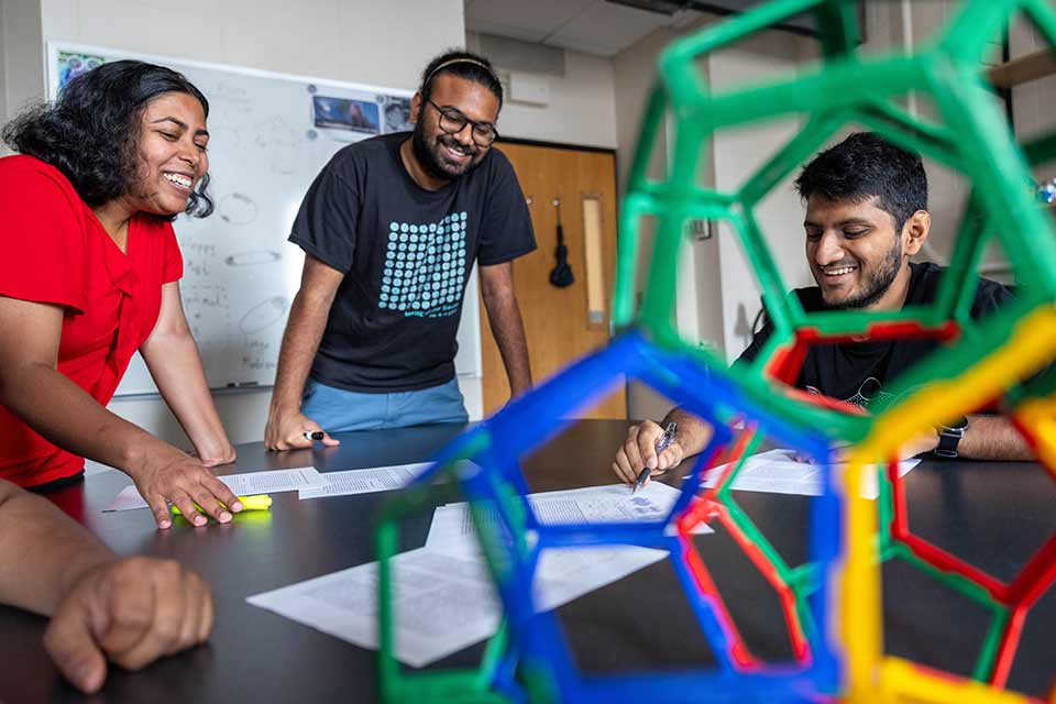 Graduate students work on physics theory