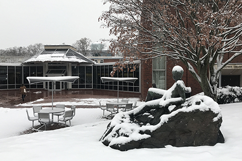 The exterior of Goldfarb Library in the snow.