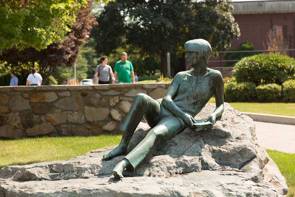A statue in front of the Brandeis Libraries