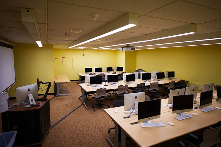 A large room filled with many desks and computers