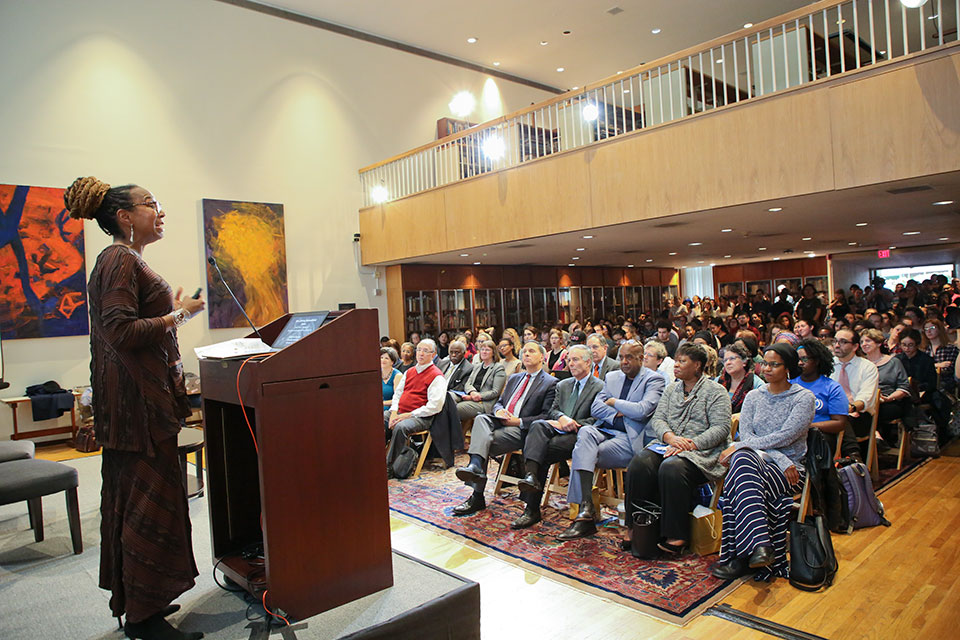 Speaker at podium talking to an audience in Rapaporte Treasure Hall