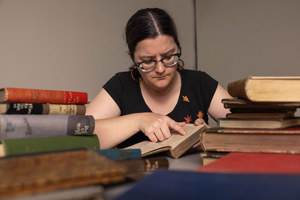 A Brandeis Librarian works with some of the JCR books.