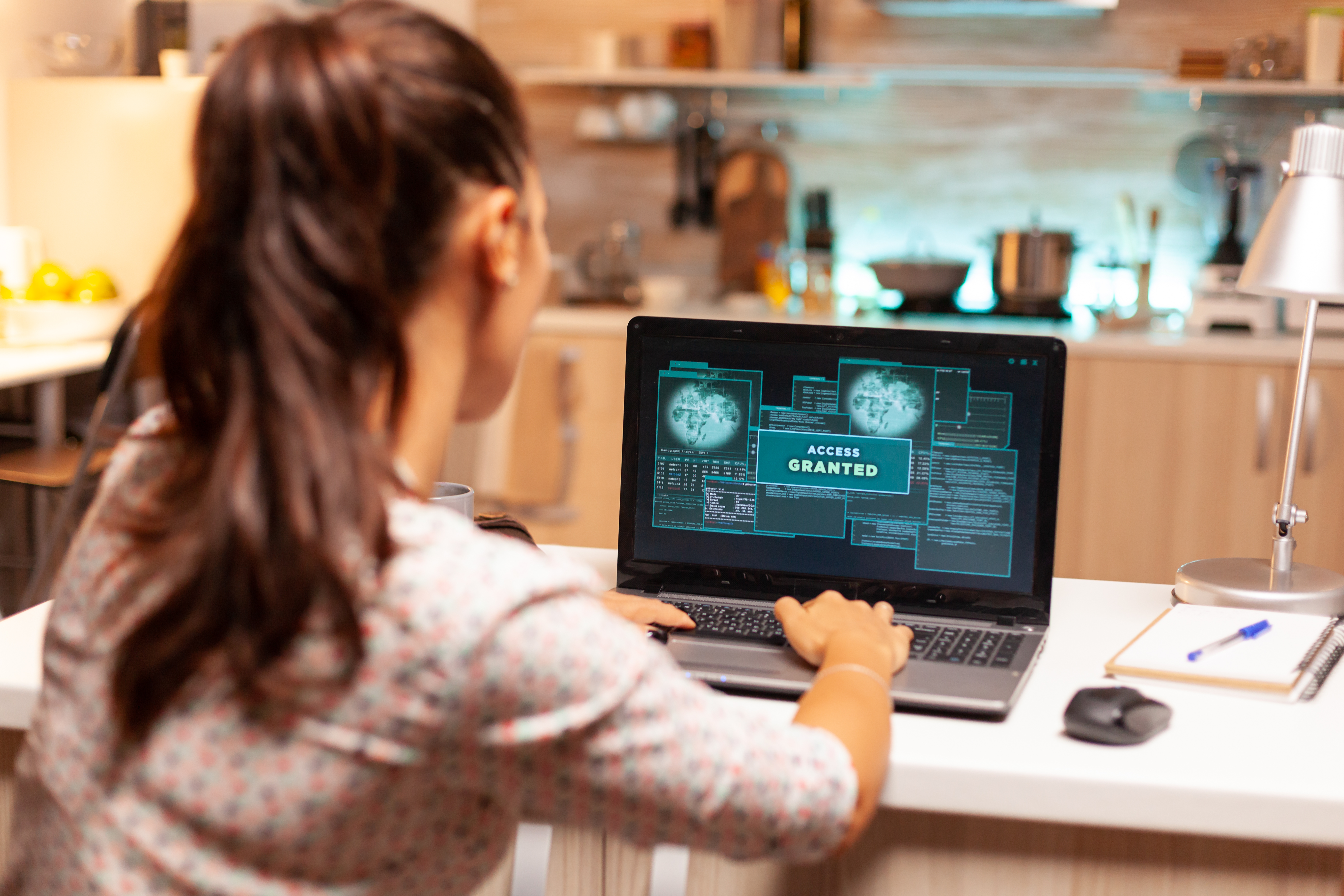 Woman attempts to hack into a program using her computer.