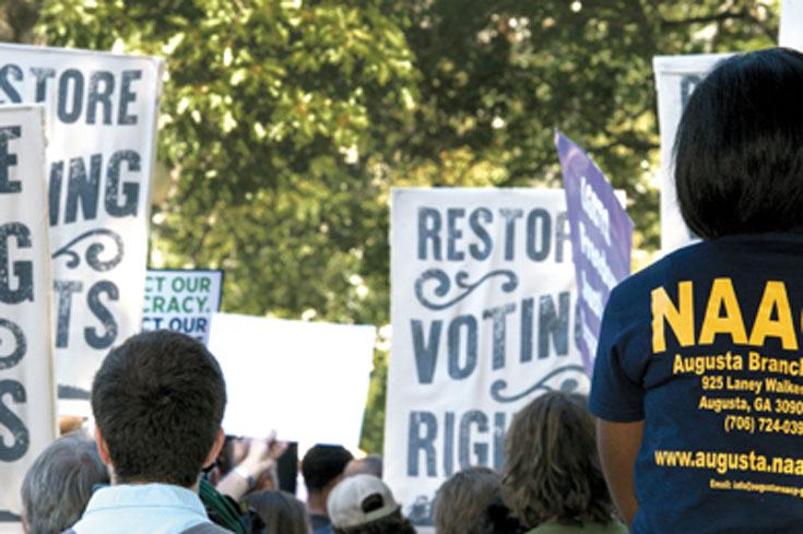 People holding up signs at a protest.