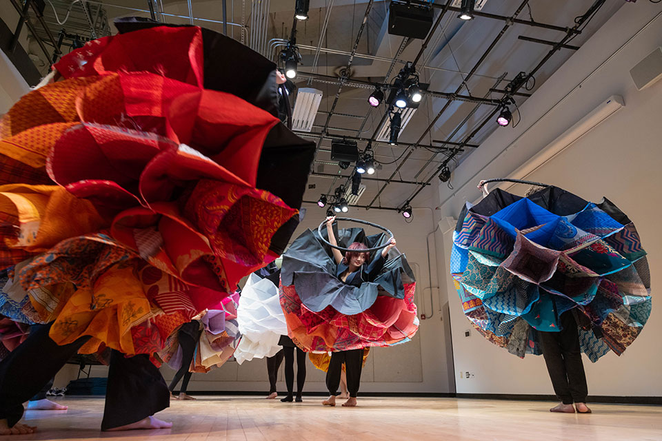 Dancers with large skirts spin on a dance floor