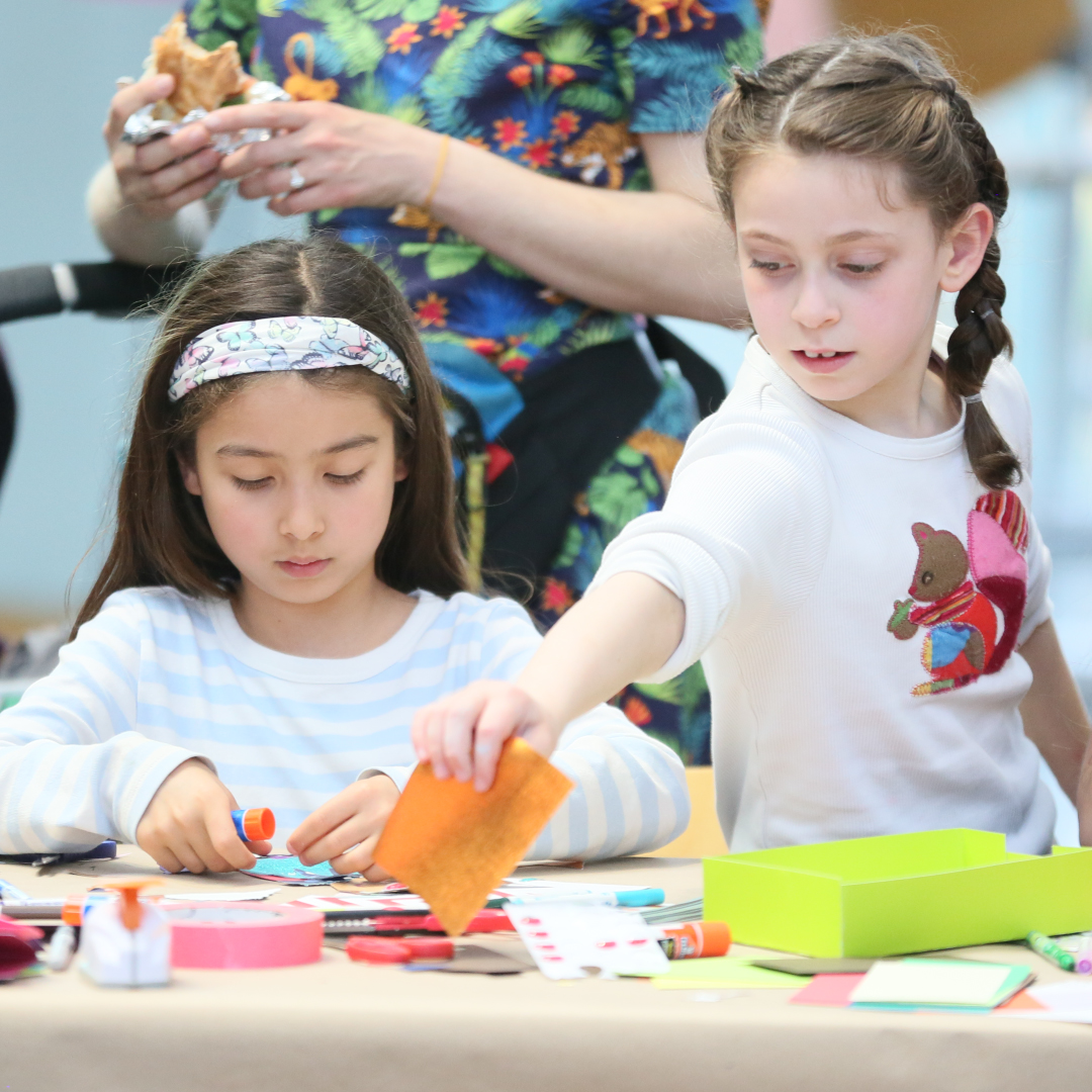 Three little girls participating in an art activity.