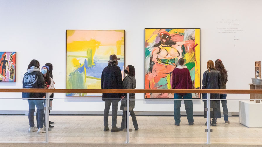 Visitors look at art in the galleries of the Rose Art Museum