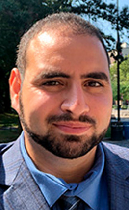Headshot of Mohamad Ballan in front of park in the background