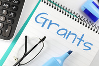 PIcture of notebook and pens with word "grants"